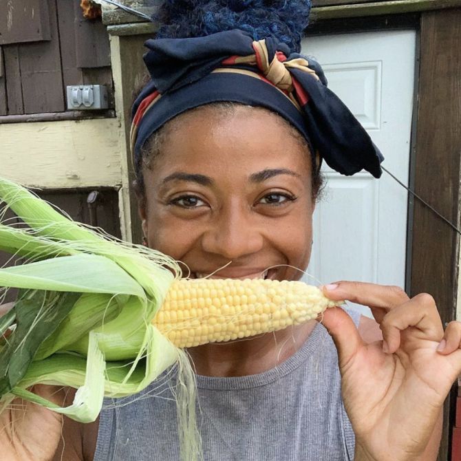 African American Woman eating corn